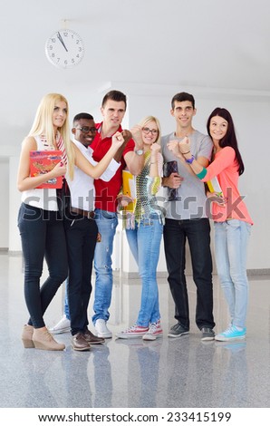 group of young students, black, white and girls successful in education, fingers up