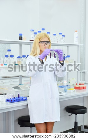 Young blonde woman scientist researcher in the laboratory of the University