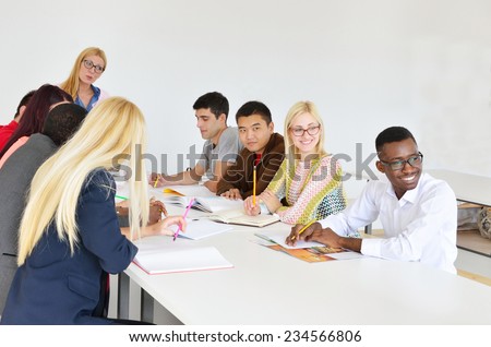Professor examines a group of young students, black, white, Chinese and girls,