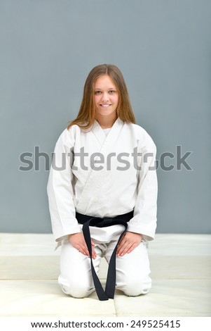 young, beautiful and successful karate women stretch out and relax before training