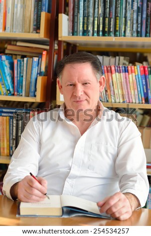 Portrait of a writer in the signing of books and thinking about the inspiration romance novel