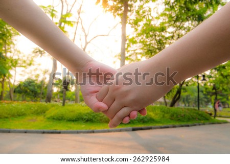 Couple holding hand in sunset