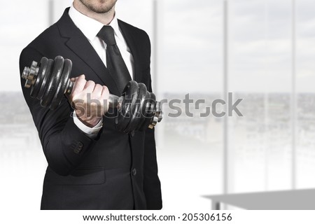 businessman in black suit wheightlifting in office