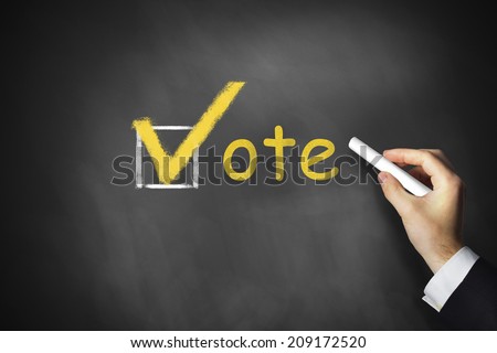hand writing vote checkbox on chalkboard