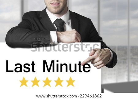 businessman in black suit pointing on sign last minute rating stars