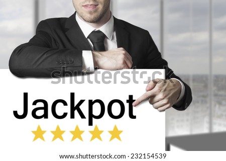 businessman black suit pointing on sign jackpot golden stars
