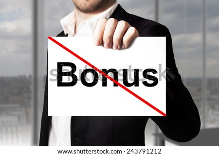 businessman in black suit holding sign bonus crossed out