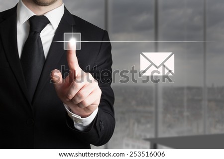 businessman in office pushing touchscreen button mail symbol