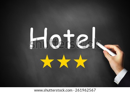 hand writing hotel on black chalkboard three rating stars