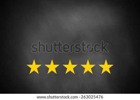 five golden rating stars on black chalkboard