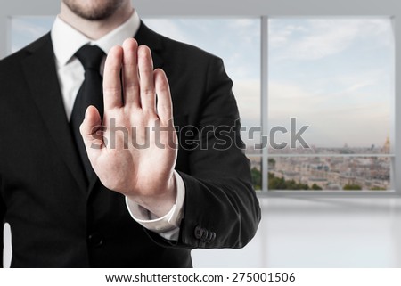 businessman in office room hand stop gesture