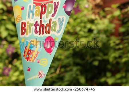 colorful birthday banner on the background of green ivy