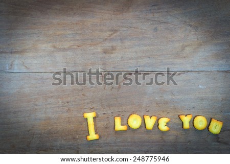 i love you text  by dessert on wooden background