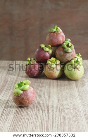 Mangosteen on wooden floor.Fresh Fruits.