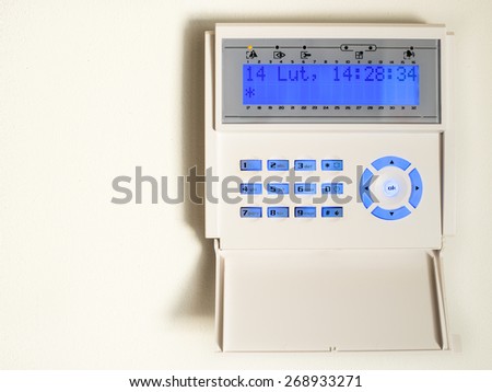 Home security alarm system activated on white wall background
