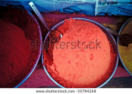 Indian paint in plates on market for sale. Red and yellow.