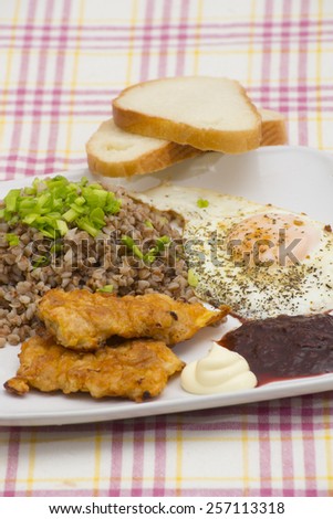 Boiled buckwheat with meat steaks, fried egg omelet with white and acid sauces, white bread recipe