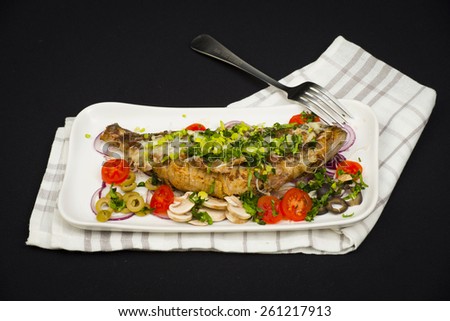 fried perch fish with cheese served in tomatoes, onions, olives and mushrooms