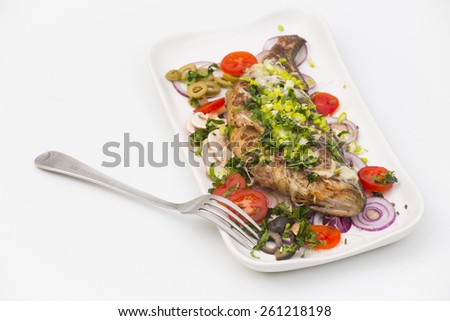 fried perch fish with cheese served in tomatoes, onions, olives and mushrooms