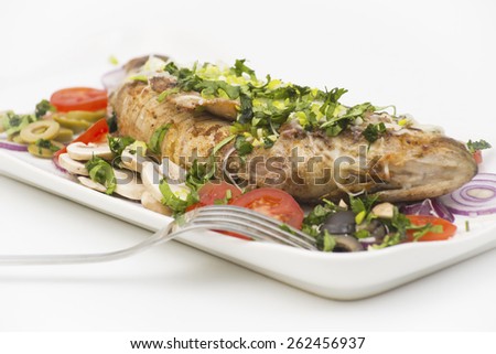baked perch fish with cheese, potatoes, onions served with boiled eggs, paprika, pickled gherkins
