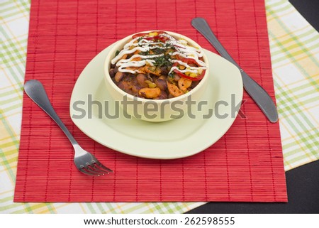 Traditional georgian baked beans with tomatoes and fried onion, carrot, greens, spices and white sauce