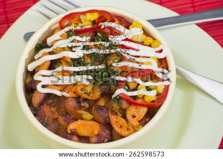 Traditional georgian baked beans with tomatoes and fried onion, carrot, greens, spices and white sauce
