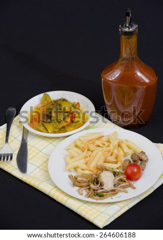 Pasta with chinese pig ears garlic soy salad, bottle of red hot chili pepper sauce and preserved paprika snack