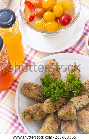 Pork cutlets with hot, sweet, yellow sweet sauces and pickled tomatoes