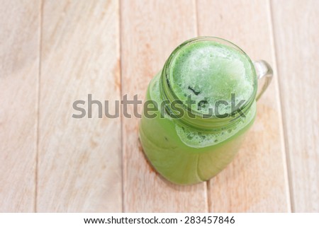 green tea smoothie on a wooden table