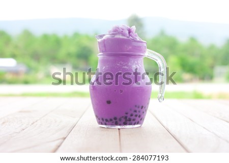 taro milk tea smoothie on a wooden table