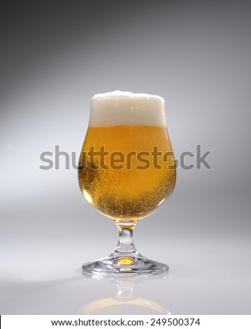 glass of beer on a gray background
