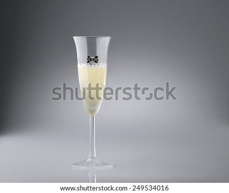 elegant glass with sparkling wine on gray gradient background