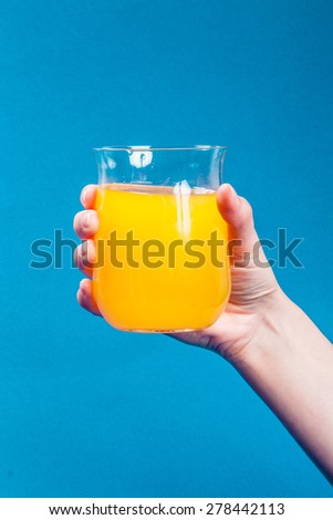 Orange juice in glass hand holding/Orange juice in glass