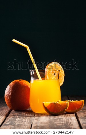 Orange juice in glass on black background/Orange juice in glass