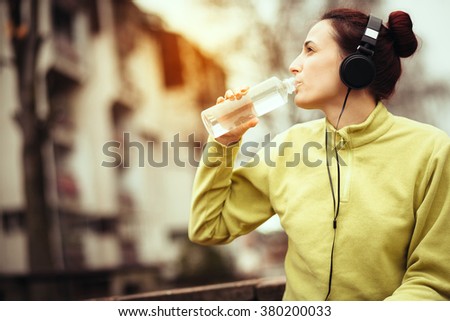 young athlete resting and refreshes after running/drinking water
