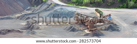 panoramic images of a stone crusher machine in an open pit mine. mining industry. images created of 5 seperate images.