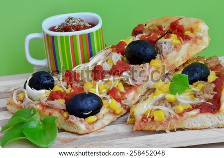 Homemade tuna pizza with mozzarella, onion, corn and olive