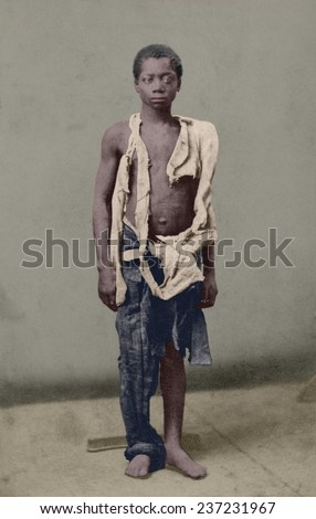 Young slave during the US Civil War clothed in rags. Ca. 1963 photograph by Armstead and White with digital color.