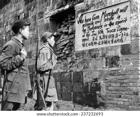 Communist Soldiers of the New Fourth Army reading a sign painted in English and Chinese urging Sino-American friendship, June 7, 1946.