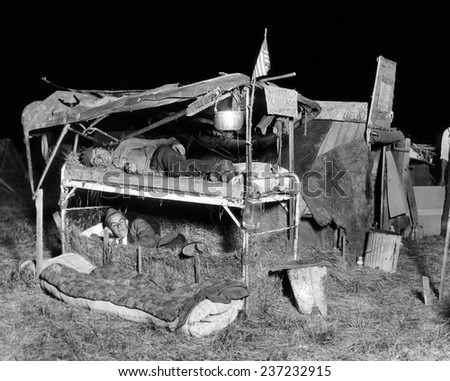 Bonus Veterans poor living conditions Two men from Detroit sleep in their primitive beds in the Anacostia Flats encampment An auto convertible top serves as a roof and the men sleep on straw.