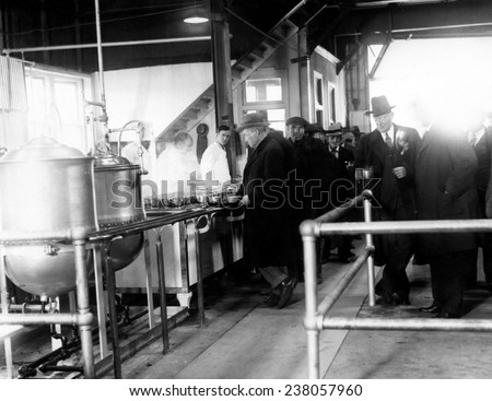 Men wait in line for food at a municipal lodging house Police Commissioner Edward P. Mulrooney stands with coffee (second from right)