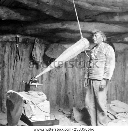 Native American having his voice recorded. Original caption reads: \'Miguelito, a Navajo from the Southwest, making a voice recording\', February 19, 1914.