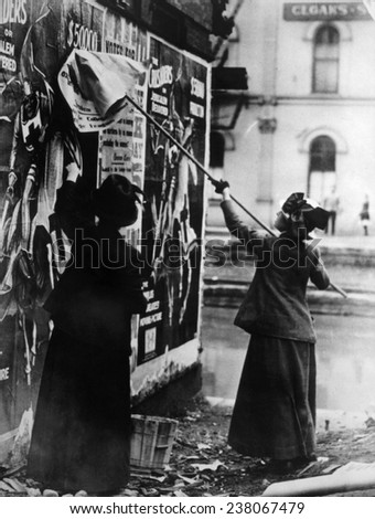 Two suffragettes posting a billboard in New York City, c, 1917,