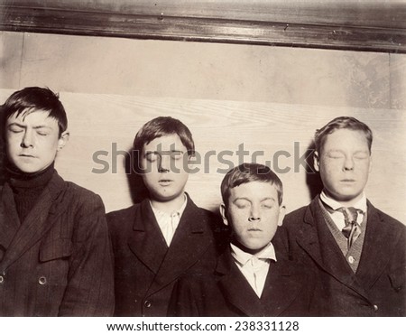 Four young men with eyes closed,\'Four incorrigibles not even reached by the Vocational School\', Buffalo, New York, photograph by Lewis Wickes Hine, February, 1910