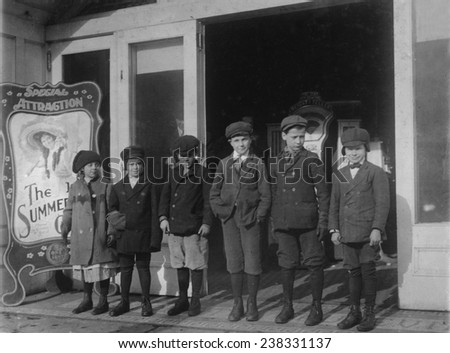 Line of children found in a penny arcade at 1:30 P.M. As many of the schools in Schenectady run on \'half time\' they are not necessarily truants.\' NY, photograph by Lewis Wickes Hine, February, 1910