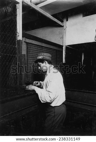 A Postal Telegraph boy learning to send messages during spare moments. Main office, Broadway, New York, photograph by Lewis Wickes Hine, July, 1910