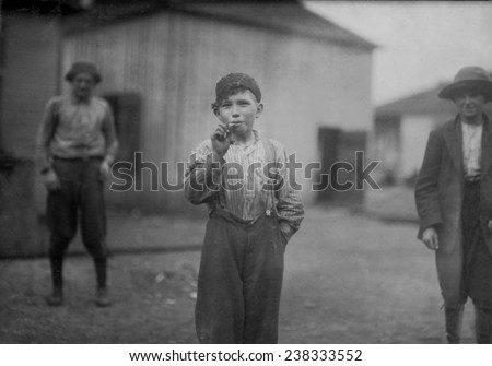 Boy smoking,\'John Tidwell, a Cotton Mill Product. Doffer in Avondale Mills. Many of these youngsters smoke.\', Birmingham, Alabama, photograph by Lewis Wickes Hine, November, 1910