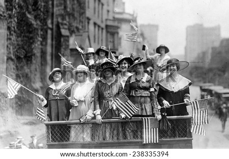 Old Glory. Group of women standing on top of vehicle waving flags, New York City, ca. 1907-1916