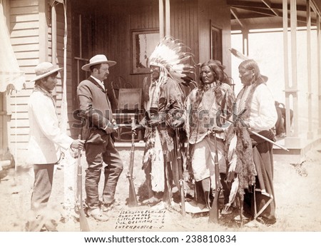 The Interview. Three Cheyenne men, Standing Elk, No. 1; Running Hog, No. 2; Little Wolf, No. 3, with Col. Oelrich, No. 4; Interpreter, No. 5. Dakota Territory. photo by John C. Grabill, 1887