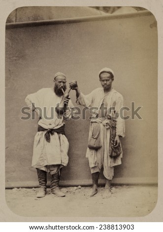 Folk festival at Ramadan, hookah smoker, original caption: \'Narodnoe gulian\'e v prazdnik \'Romazan\'. Kal\'ianshchik\', photograph circa 1865-1872